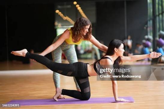 Professional yoga instructor demonstrating a standing pose